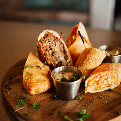 Buffalo chicken eggrolls on a board