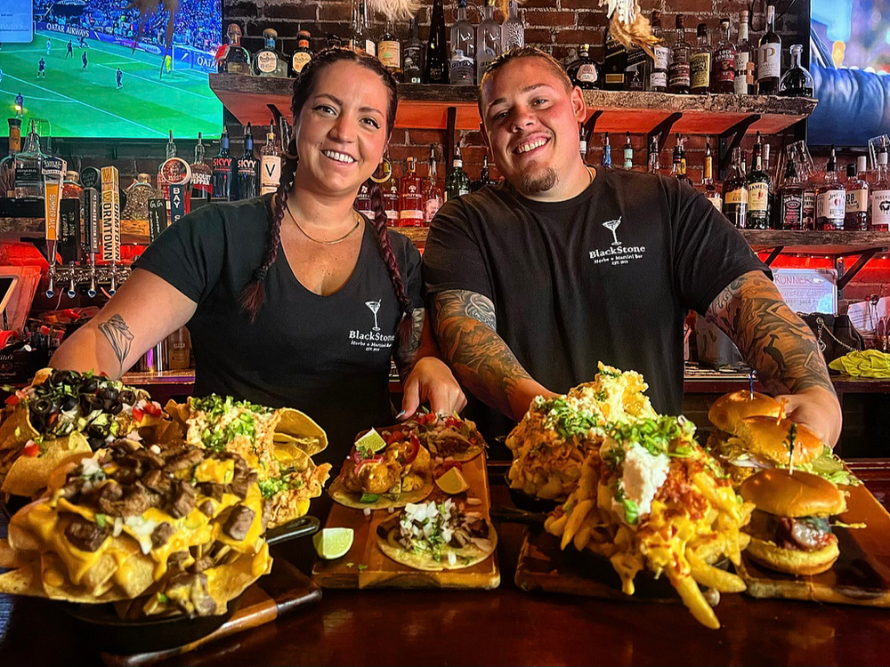 The Blackstone team behind the bar with food flights
