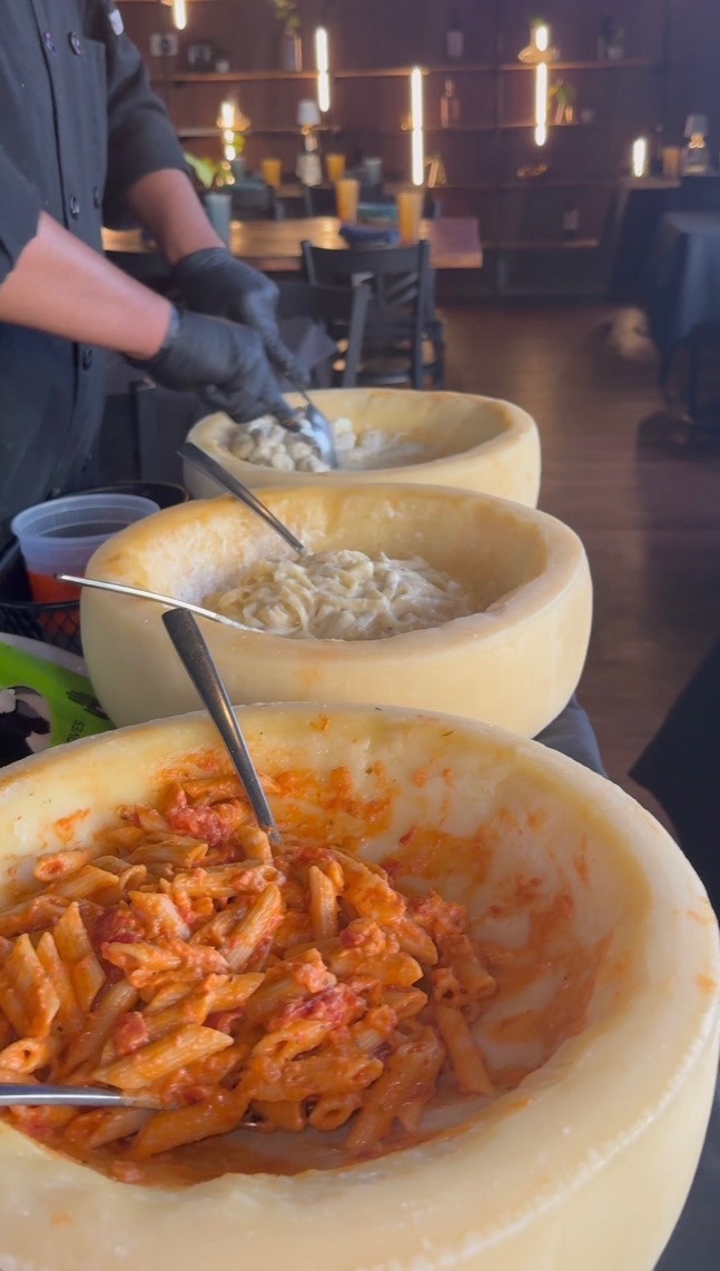 Pasta tossed table-side in Parmigiano Reggiano cheese wheels
